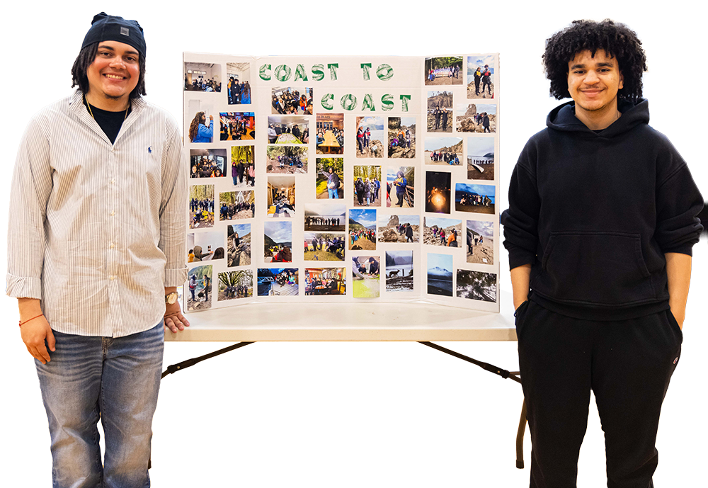 Students standing in front of their science poster at the Youth Symposium